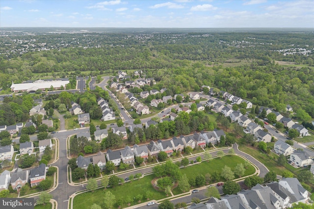 birds eye view of property featuring a wooded view and a residential view