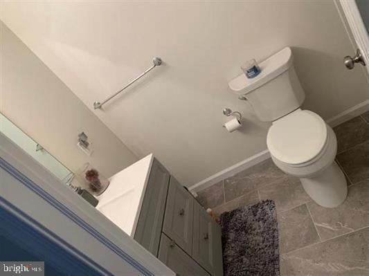 25 Bucknell Rd, Somers Point, NJ 08244 - bathroom with toilet, baseboards, and vanity