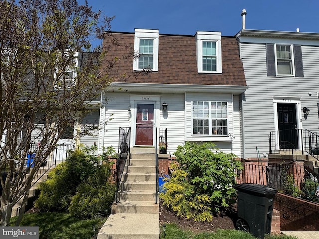 multi unit property with roof with shingles and mansard roof