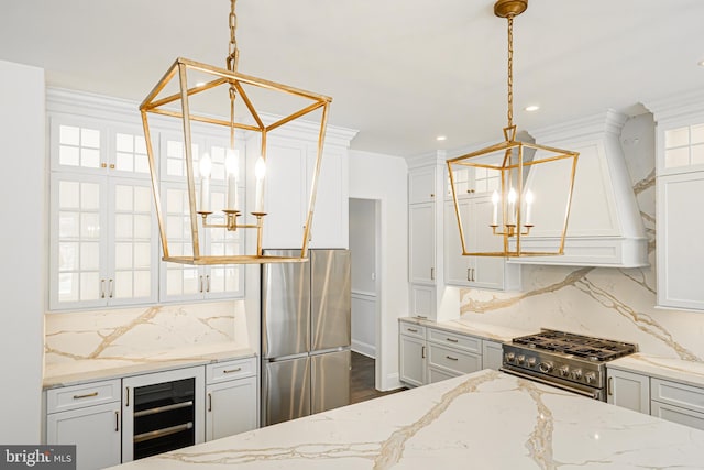 kitchen featuring decorative backsplash, white cabinetry, a notable chandelier, and stainless steel appliances