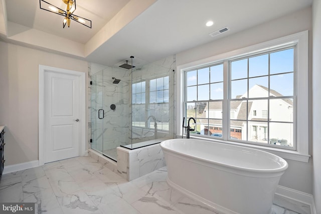full bath featuring a freestanding bath, baseboards, a marble finish shower, and marble finish floor
