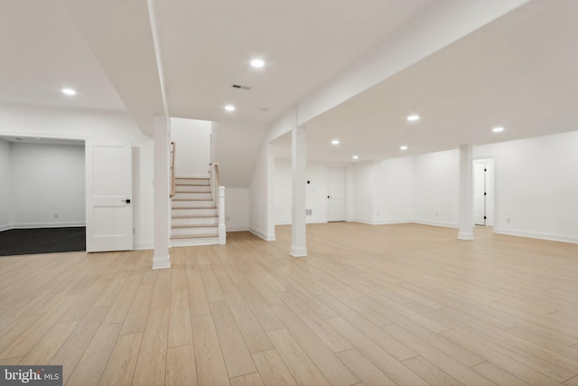finished below grade area with recessed lighting, stairs, and light wood finished floors