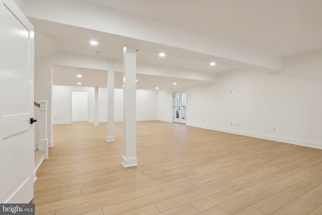 finished below grade area featuring recessed lighting, baseboards, and light wood-style flooring