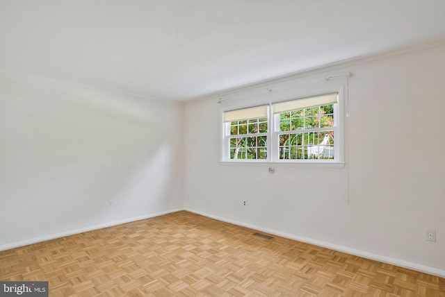 empty room with baseboards and visible vents