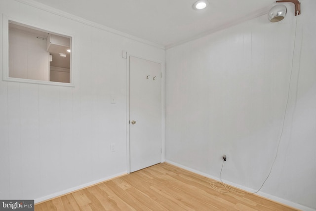 unfurnished room featuring crown molding, baseboards, and light wood finished floors