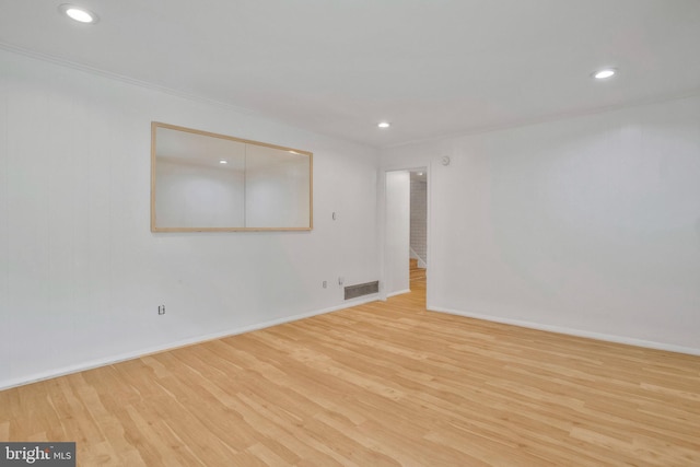 unfurnished room featuring recessed lighting, baseboards, visible vents, and wood finished floors