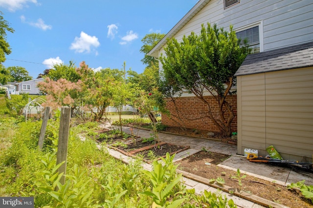 view of yard with a garden and fence