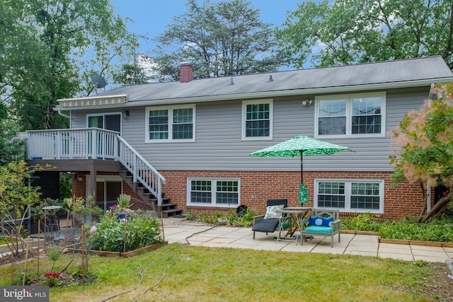 rear view of house with a patio, stairs, a yard, and a deck