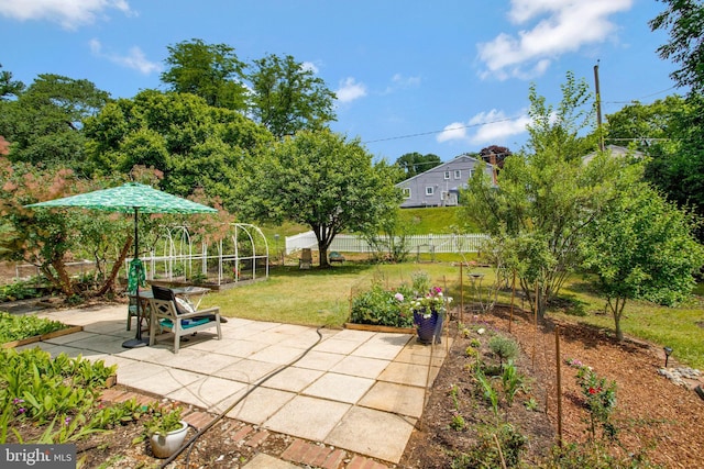 view of patio / terrace with a garden and fence