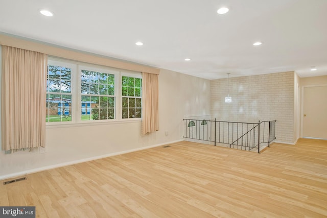 spare room with recessed lighting, visible vents, and wood finished floors