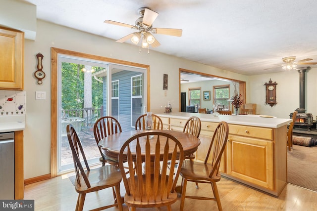 13478 Spruce, King George, VA 22485 - dining area with a wood stove, a ceiling fan, and light wood-type flooring
