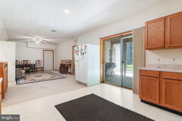 13478 Spruce, King George, VA 22485 - kitchen with white refrigerator with ice dispenser, light floors, ceiling fan, brown cabinets, and vaulted ceiling