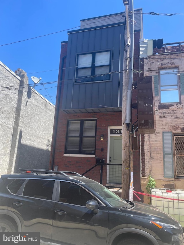 1321 S Dover St, Philadelphia, PA 19146 - view of front of home featuring brick siding and board and batten siding