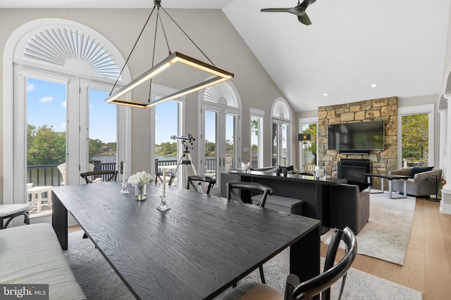 910 Lynch Dr, Arnold, MD 21012 - dining space with a fireplace, high vaulted ceiling, plenty of natural light, and light wood-type flooring