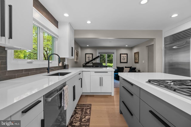 910 Lynch Dr, Arnold, MD 21012 - kitchen featuring light wood-type flooring, a sink, light countertops, stainless steel appliances, and white cabinetry