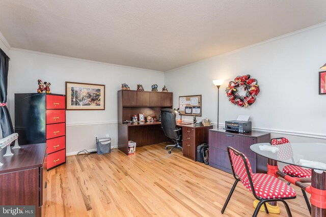 office area with crown molding and light wood finished floors