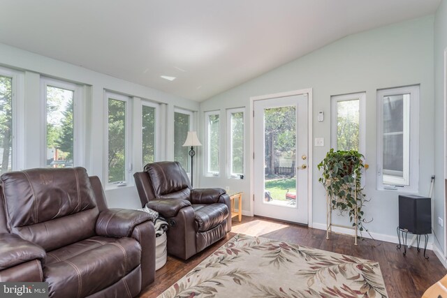 living room with baseboards, vaulted ceiling, and wood finished floors