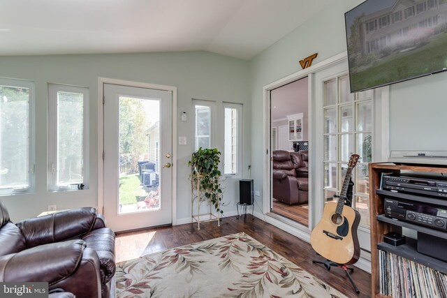doorway to outside featuring dark wood-style flooring and vaulted ceiling