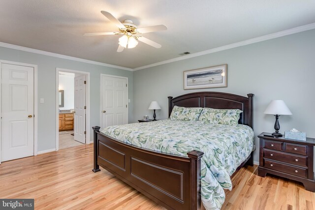 bedroom with light wood-style floors, baseboards, crown molding, and visible vents