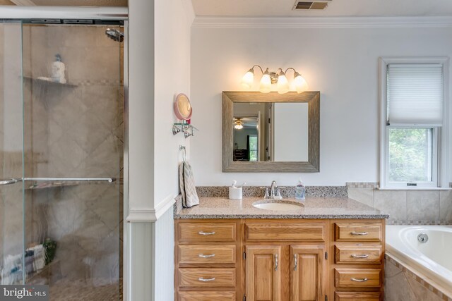 full bathroom with crown molding, vanity, a bath, and a stall shower