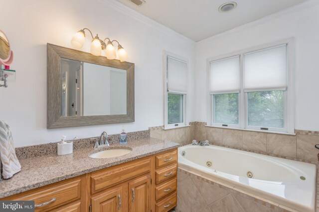 full bathroom featuring vanity, crown molding, and a tub with jets