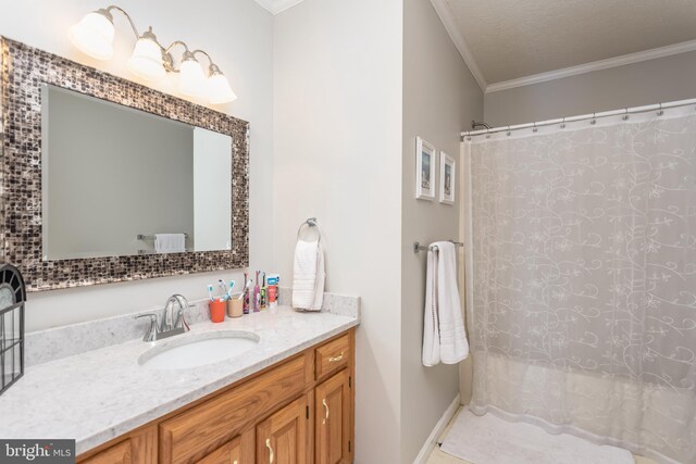 full bathroom with ornamental molding, a shower with shower curtain, and vanity