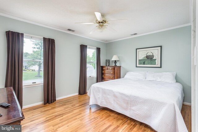 bedroom with visible vents, light wood-style flooring, and baseboards