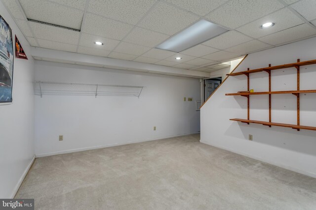 finished basement featuring recessed lighting, light carpet, and a paneled ceiling