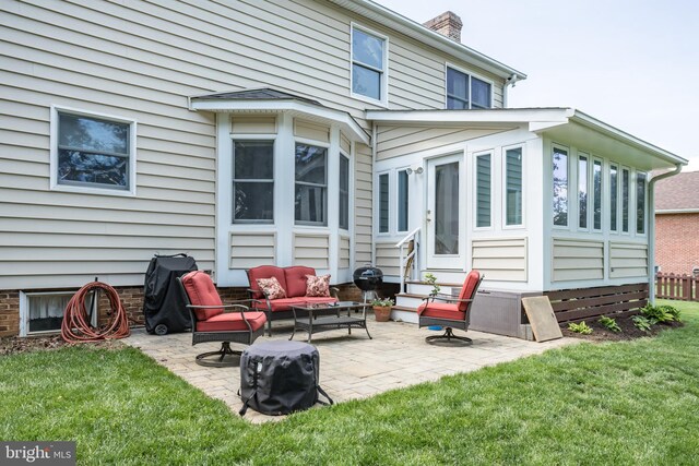 rear view of property with a lawn, a patio, a chimney, and outdoor lounge area