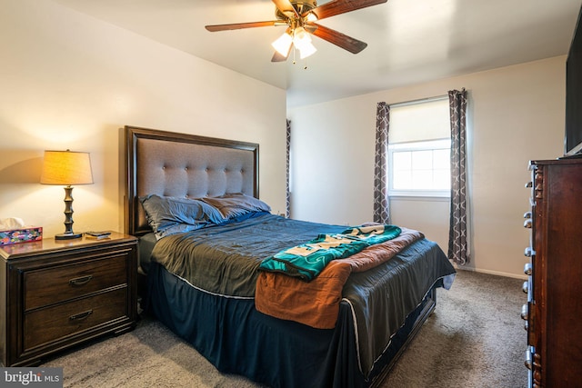 carpeted bedroom featuring baseboards and a ceiling fan