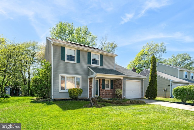 traditional-style house with a garage, concrete driveway, a front yard, and brick siding