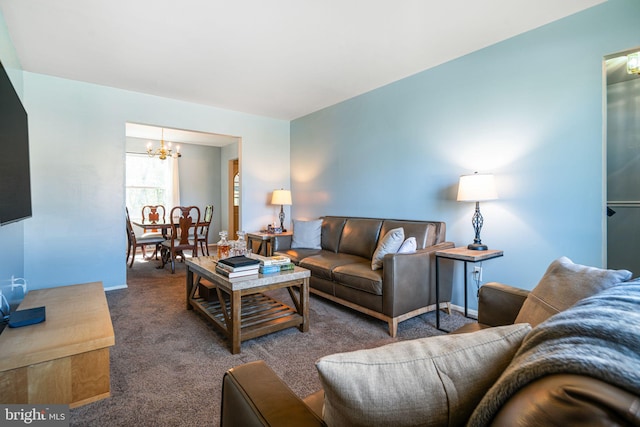 carpeted living room featuring a notable chandelier