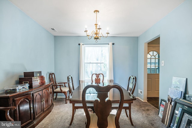 dining area with a chandelier, carpet, a wealth of natural light, and visible vents