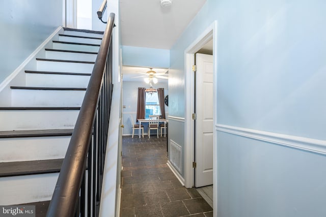 stairs with a ceiling fan and visible vents