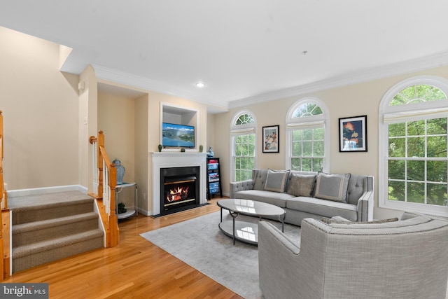 8878 Ashgrove House Ln, Vienna, VA 22182 - living area with light wood finished floors, stairway, ornamental molding, and a fireplace with flush hearth