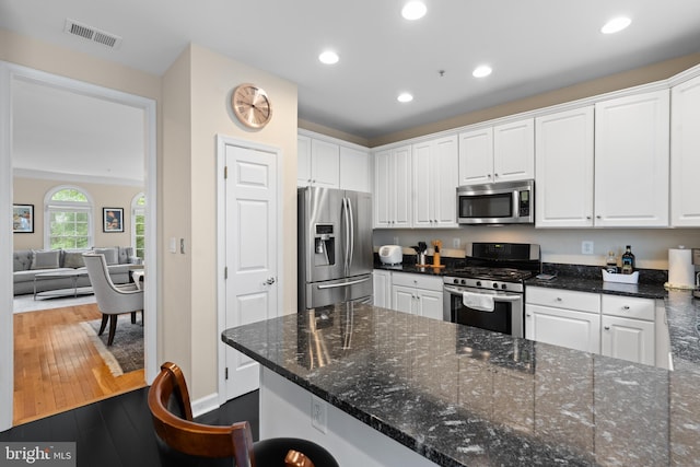 8878 Ashgrove House Ln, Vienna, VA 22182 - kitchen featuring stainless steel appliances, white cabinets, and hardwood / wood-style flooring