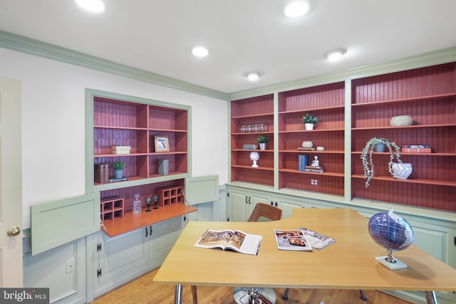 office space with ornamental molding and light wood finished floors