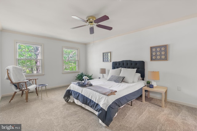 carpeted bedroom with crown molding, a ceiling fan, and baseboards