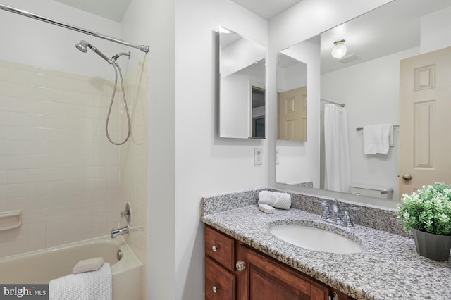 bathroom featuring vanity, shower / bath combo, and visible vents