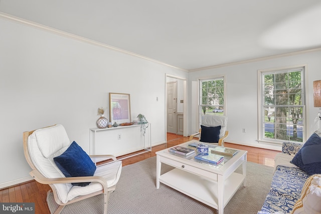living room with baseboards, ornamental molding, and wood finished floors