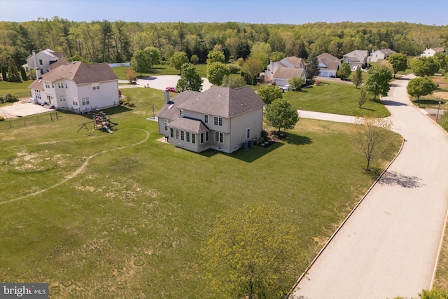 bird's eye view featuring a residential view and a forest view