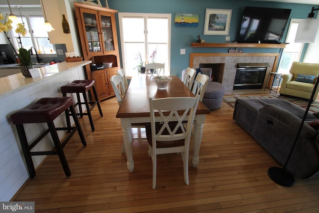 646 River Oak Ct Unit A-8Bs, Salisbury, MD 21801 - dining area featuring light wood-style flooring and a tile fireplace