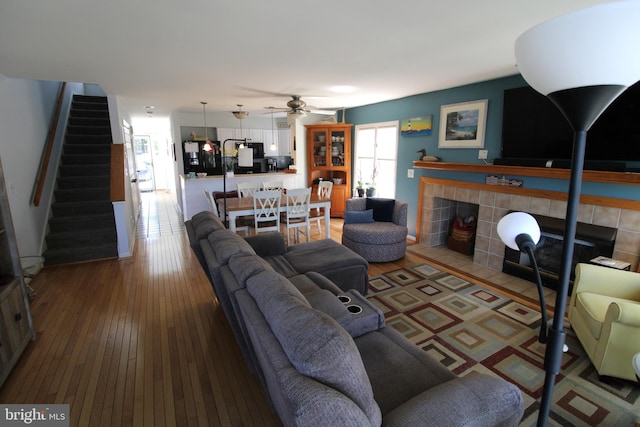 646 River Oak Ct Unit A-8Bs, Salisbury, MD 21801 - living area with a tile fireplace, stairs, a ceiling fan, and hardwood / wood-style floors