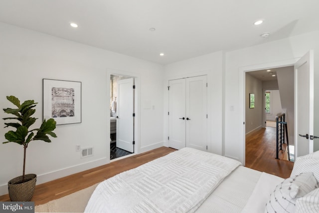 bedroom with visible vents, recessed lighting, baseboards, and wood finished floors