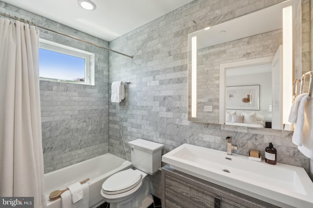 bathroom with vanity, shower / tub combo with curtain, decorative backsplash, toilet, and tile walls