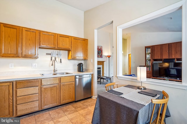 7524 Snowpea Ct Unit 9, Alexandria, VA 22306 - kitchen with stainless steel dishwasher, light tile patterned flooring, light countertops, brown cabinets, and a sink