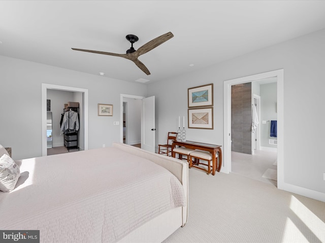 bedroom featuring carpet floors, a ceiling fan, baseboards, and ensuite bath
