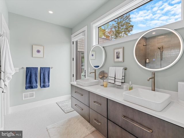 full bathroom featuring double vanity, visible vents, a sink, and recessed lighting