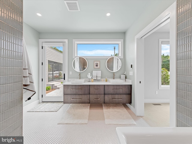 full bath with recessed lighting, visible vents, and a sink