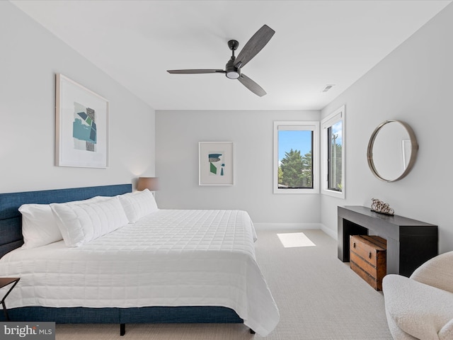 carpeted bedroom featuring visible vents, baseboards, and ceiling fan